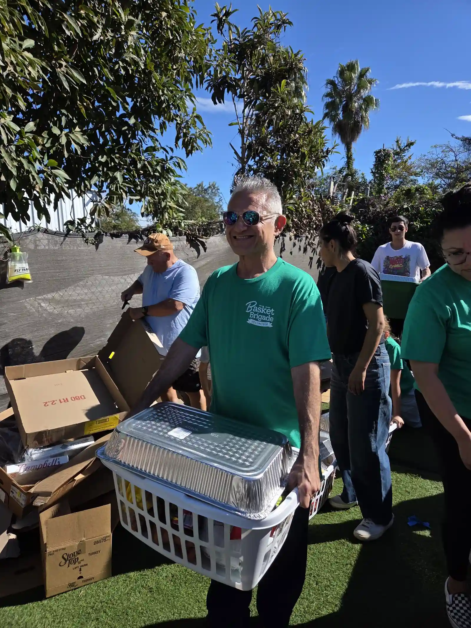 Volunteer carries a basket of donated food at Santa Barbara Dojo's Basket Brigade
