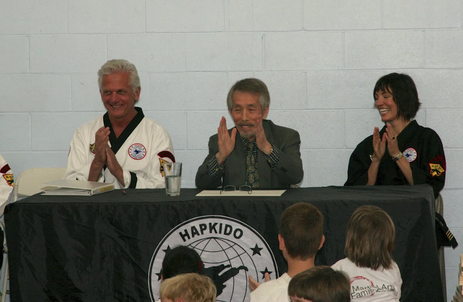Grandmaster Dave, Grandmaster Yi and Master Mel seated at the Hapkido judging table